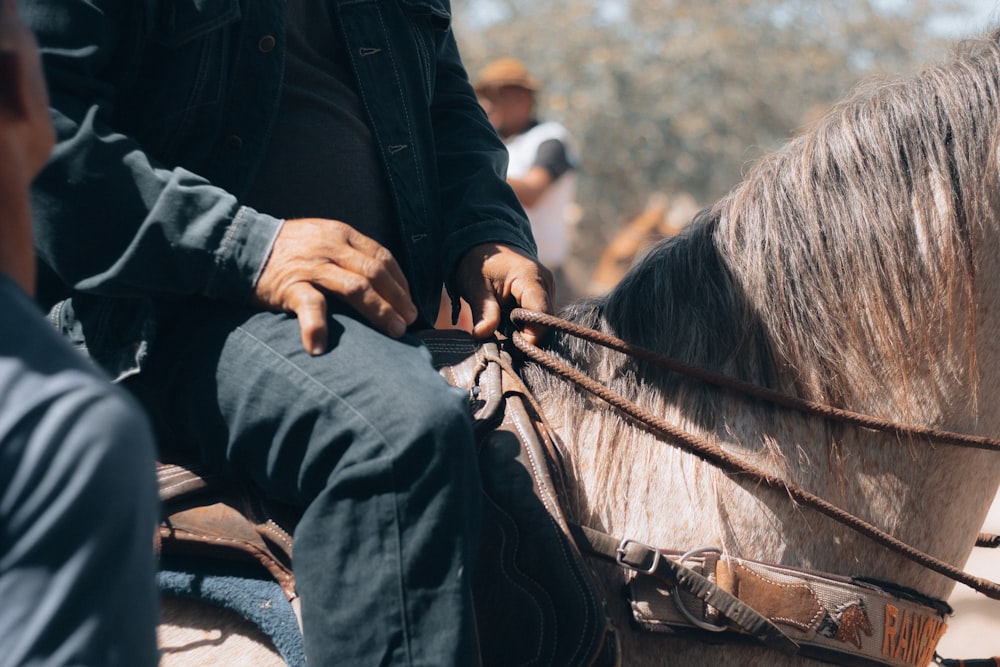 a close up of a person riding a horse