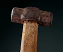 a close up of a hammer with a black background