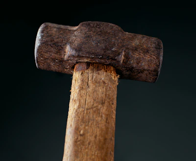a close up of a hammer with a black background
