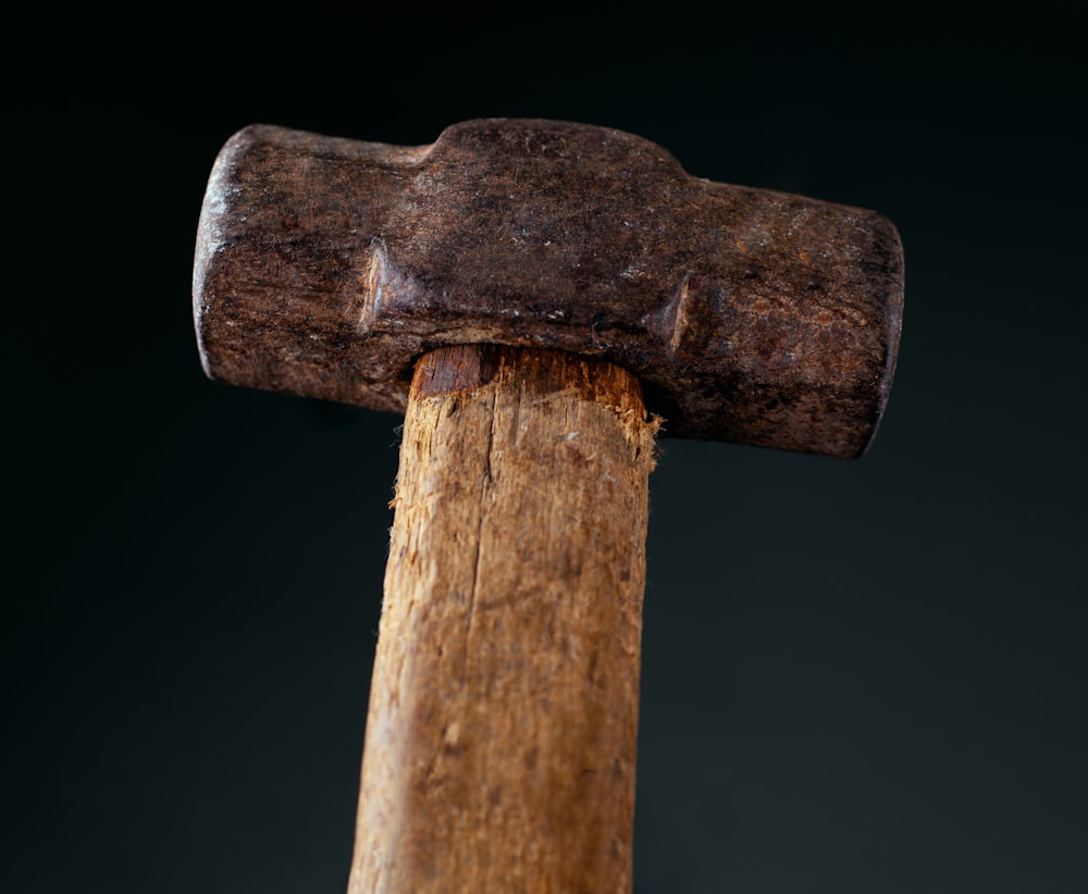 a close up of a hammer with a black background