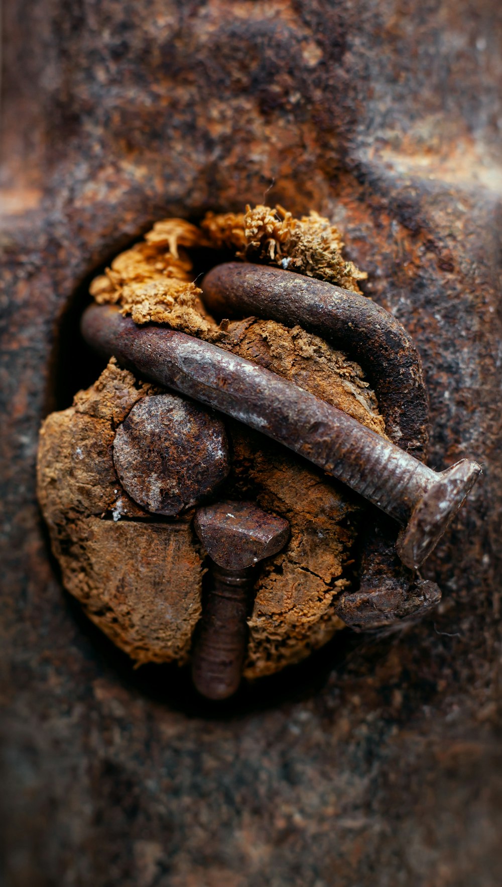 a rusted metal surface with a rusty screwdriver