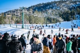 a crowd of people standing on top of a snow covered slope