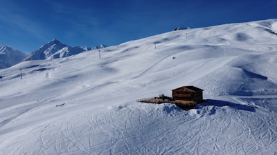 Snow-covered alpine landscape around the cabin in winter.