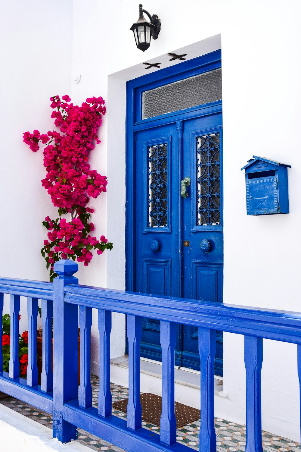 a blue and white house with a blue door