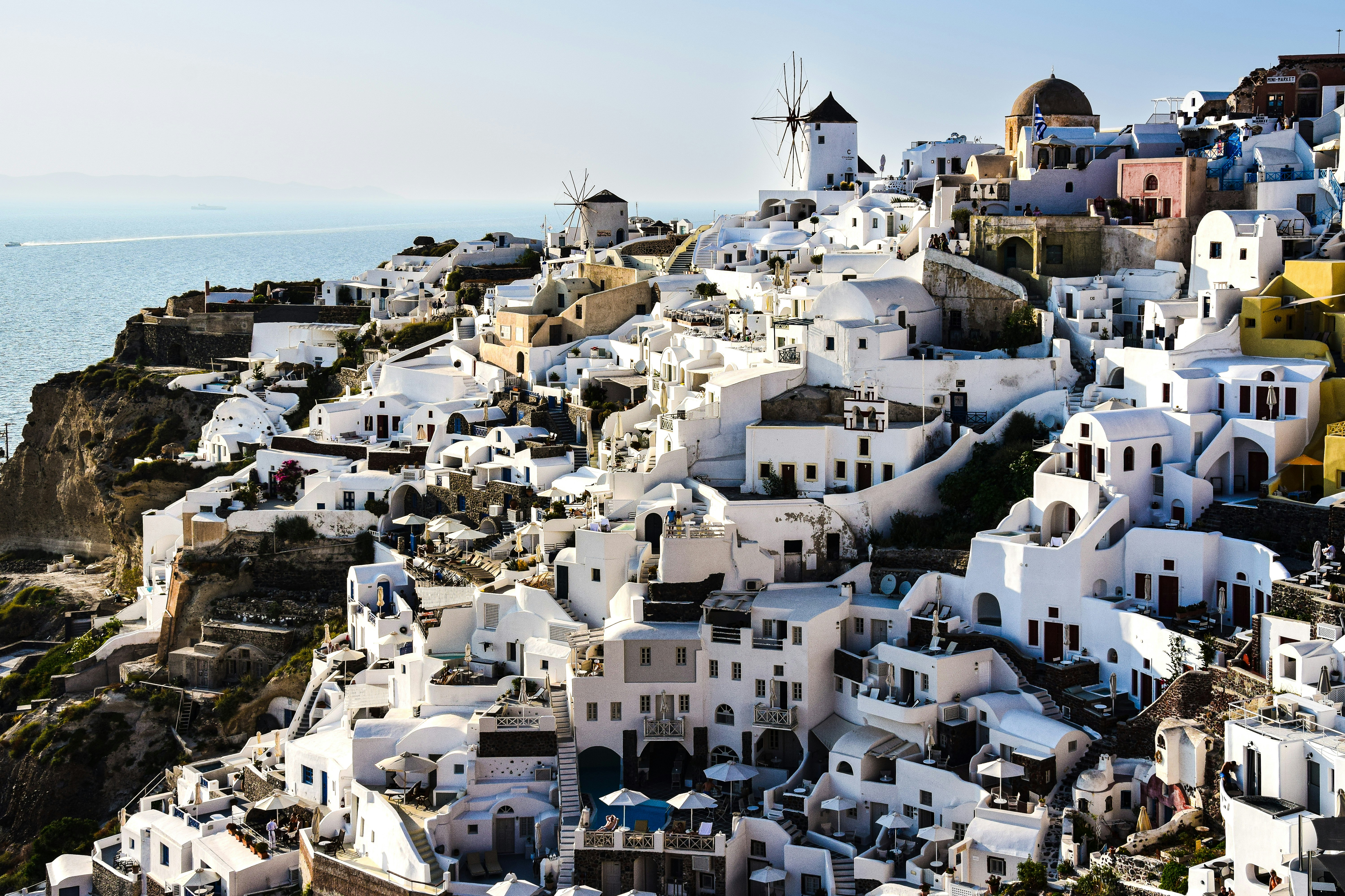 a view of a village on a cliff overlooking the ocean, Santorini, Greece.