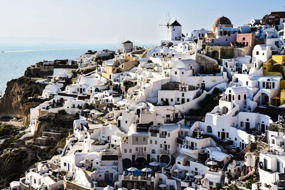 a view of a village on a cliff overlooking the ocean