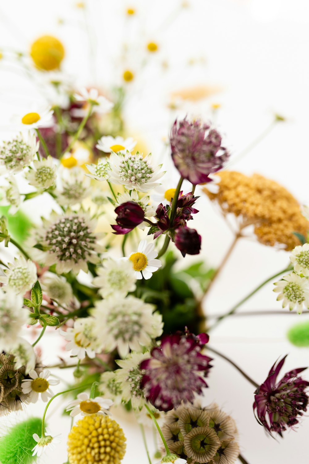 a vase filled with lots of different colored flowers