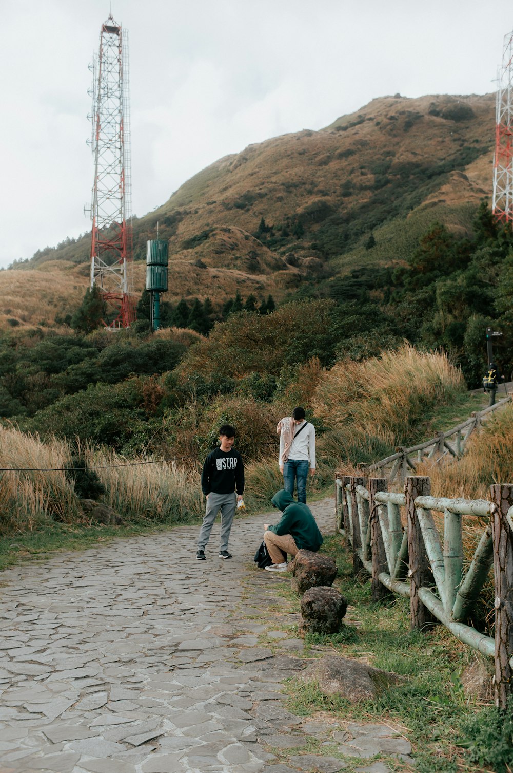 a group of people standing on top of a stone road