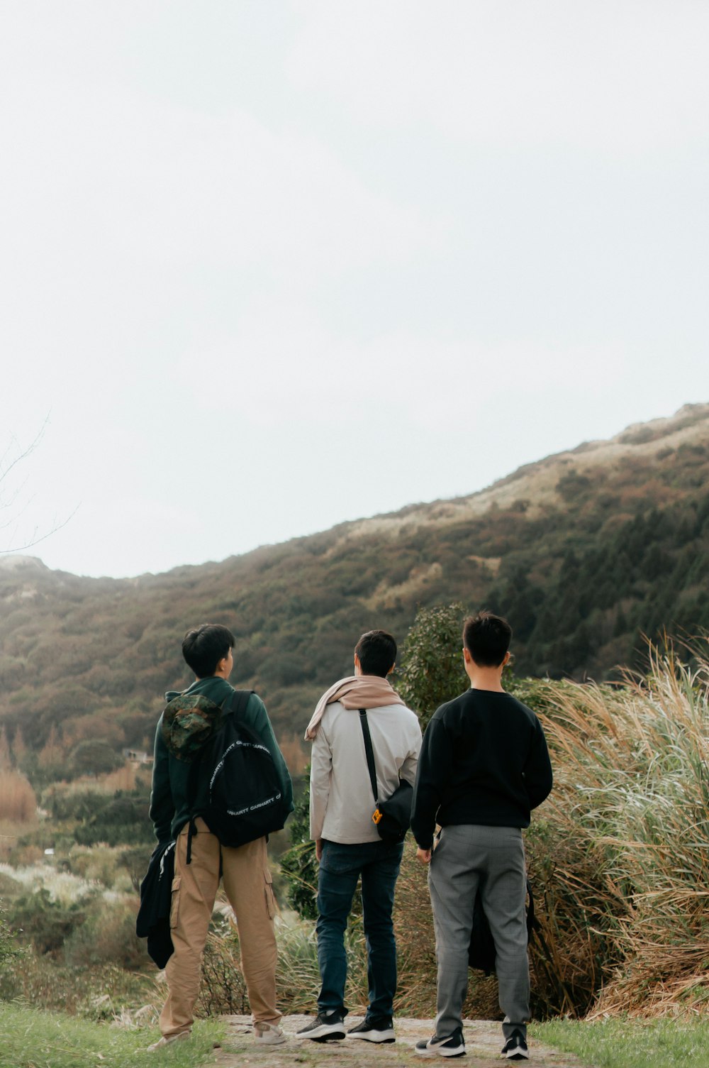 a group of people standing on top of a hill