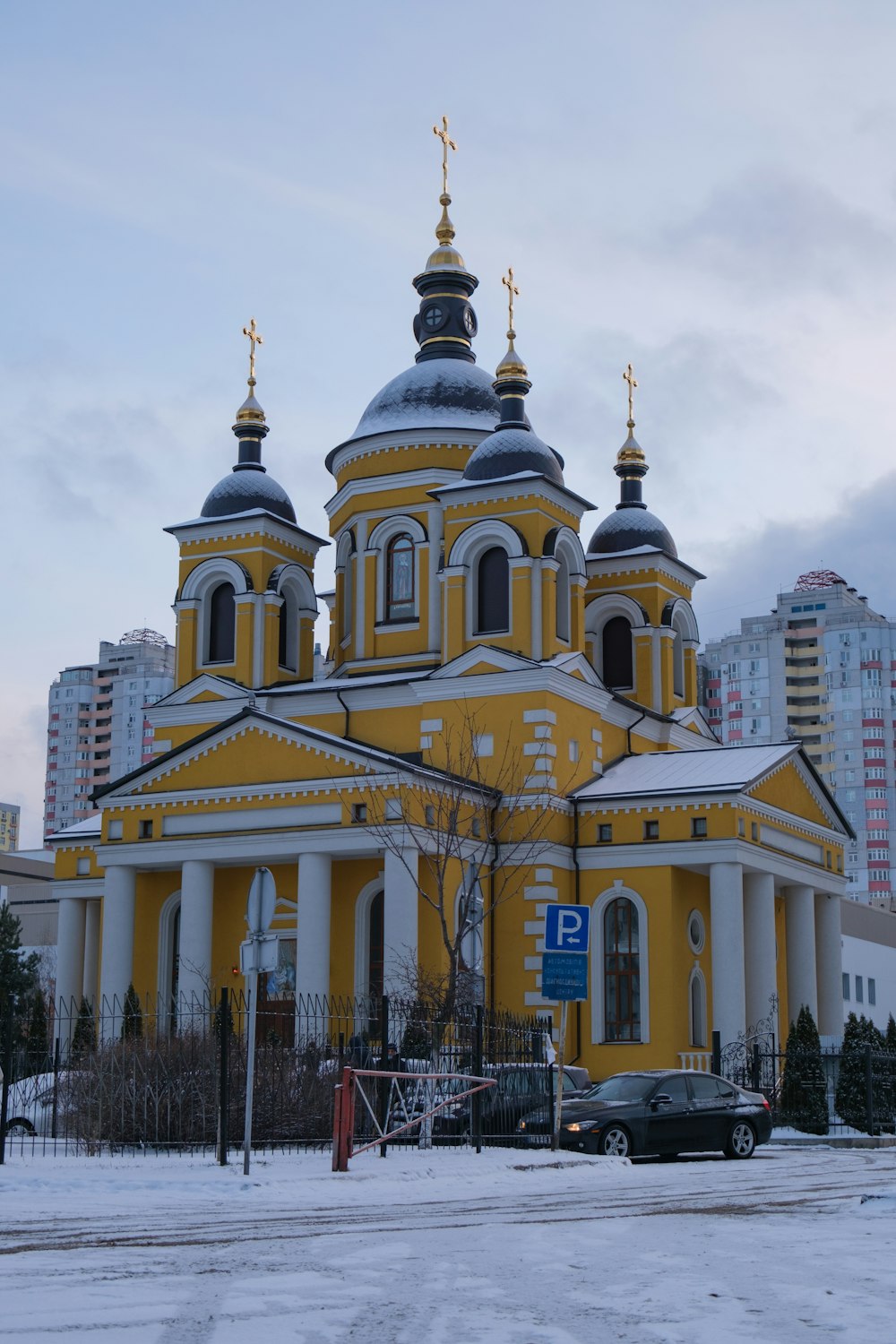 a large yellow and white building with two towers