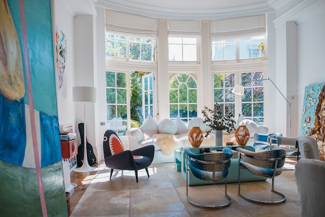 Sunlit, freshly renovated modern living room with bespoke furniture and artistic interior details.