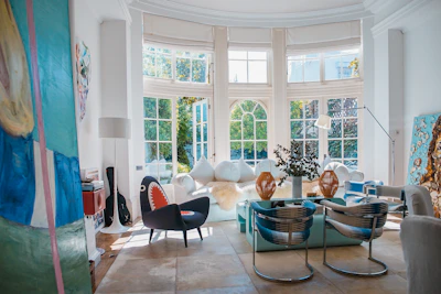 Bright, airy living room with neatly arranged furniture and soft pastel tones reflecting Mediterranean coastal style.
