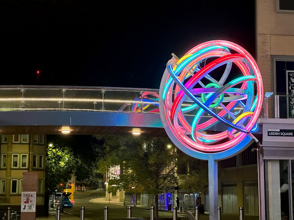 a colorful light sculpture in the middle of a street