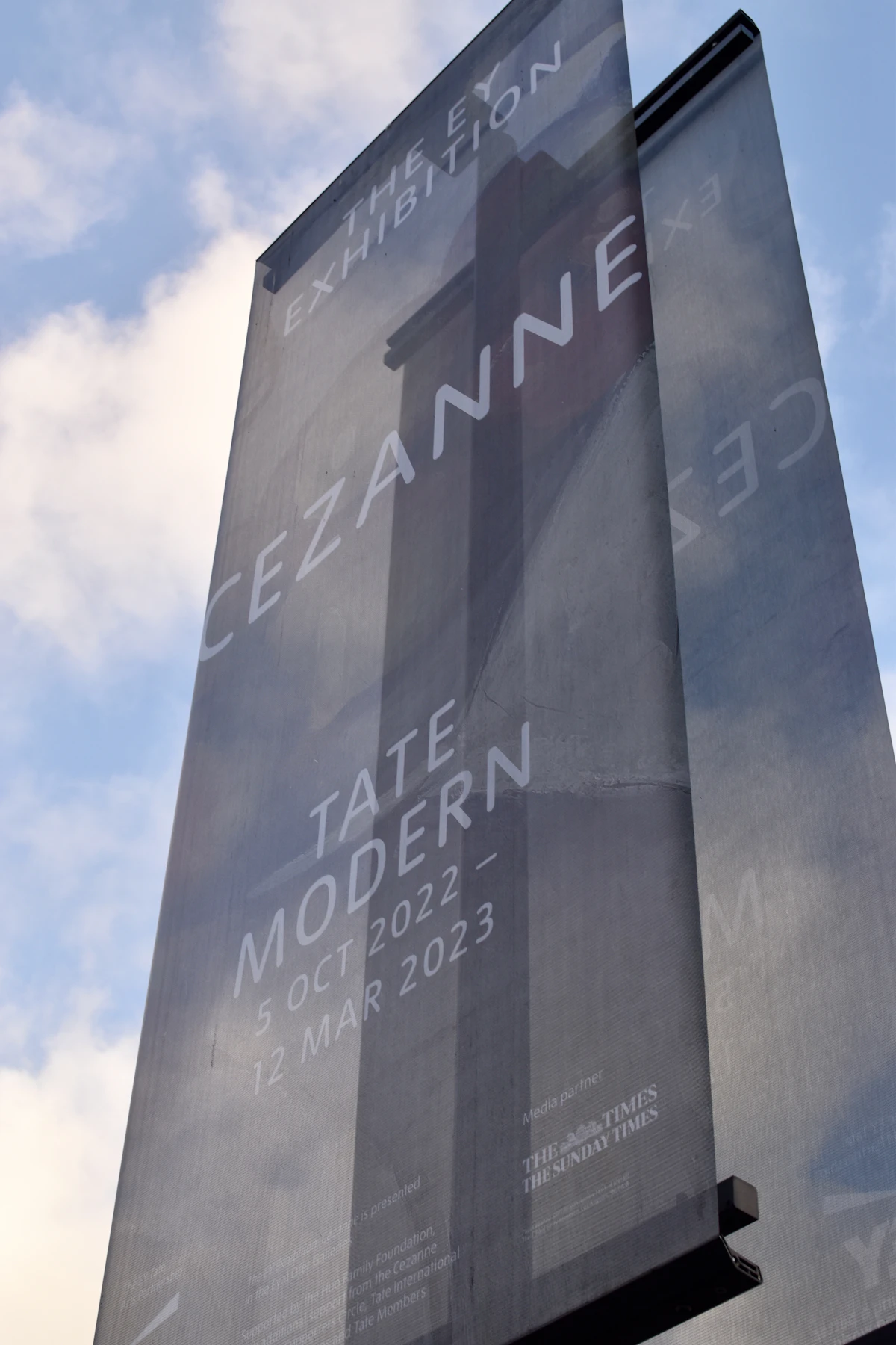 Large printed display on the side of a city building