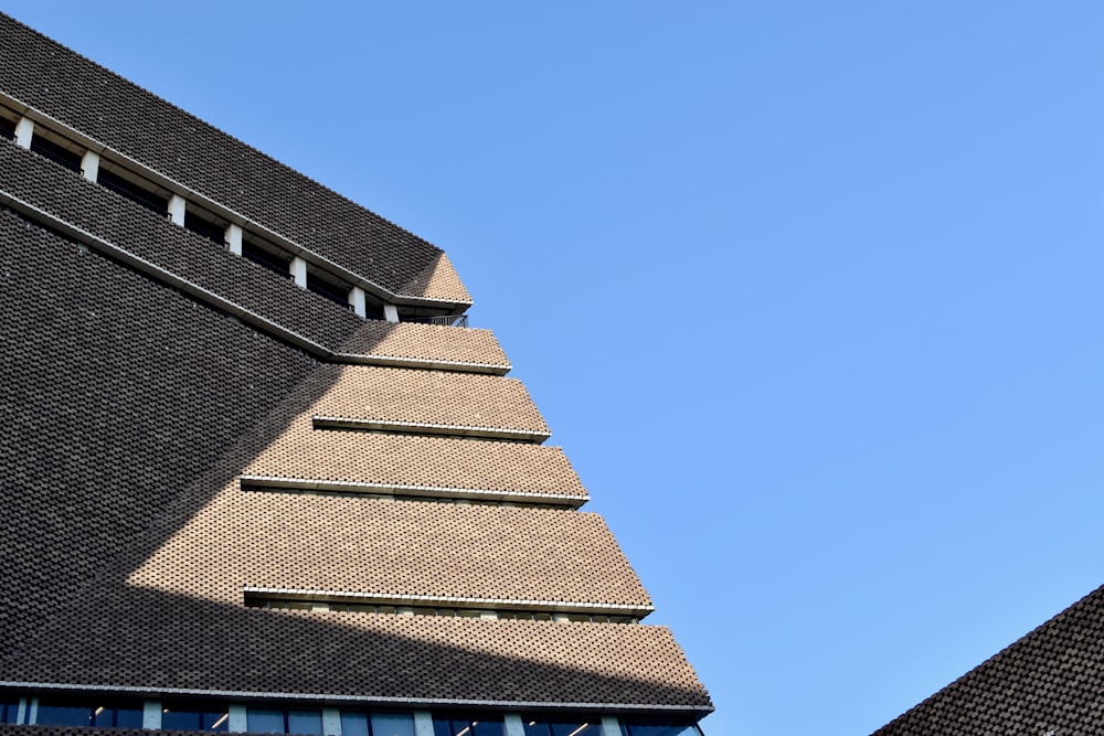 a clock on the side of a building with a sky background