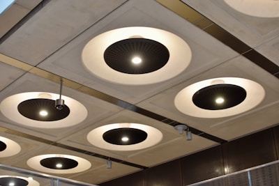 Clean-lined recessed ceiling lights casting even illumination across a monochrome commercial space
