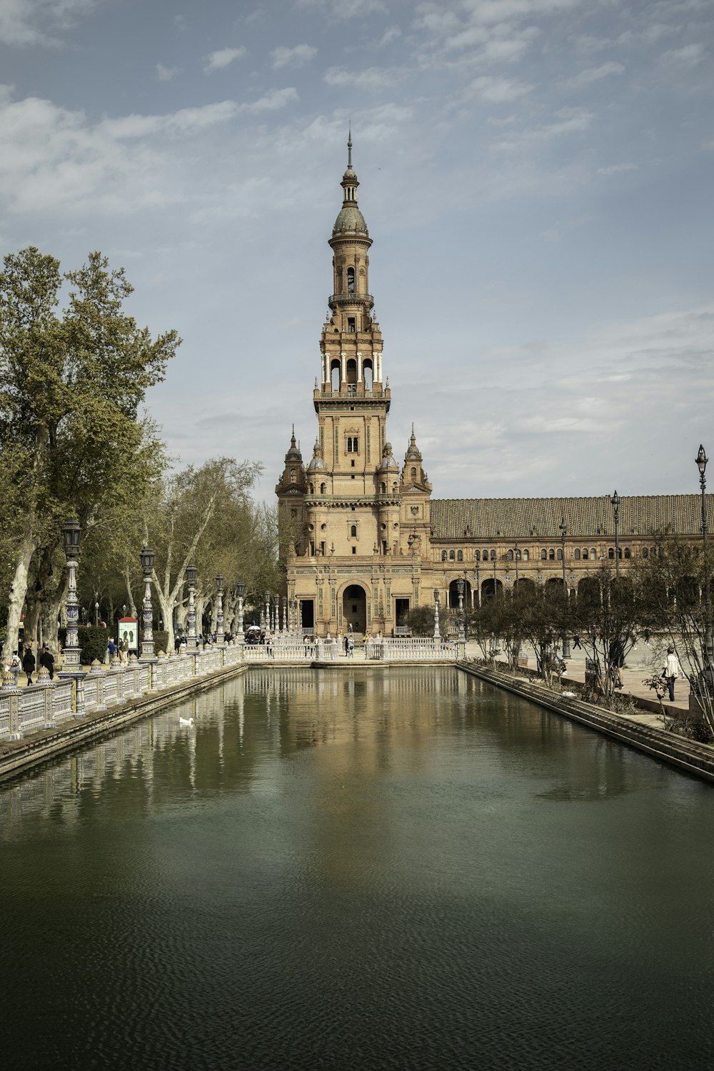 a large building with a tower next to a body of water