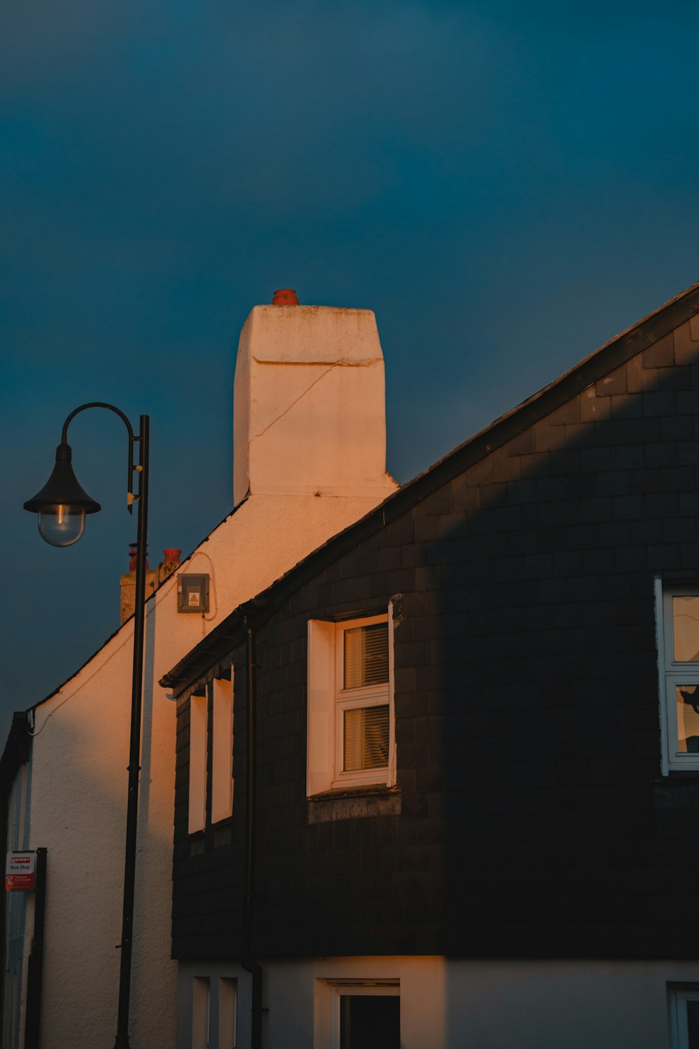 a street light next to a black building