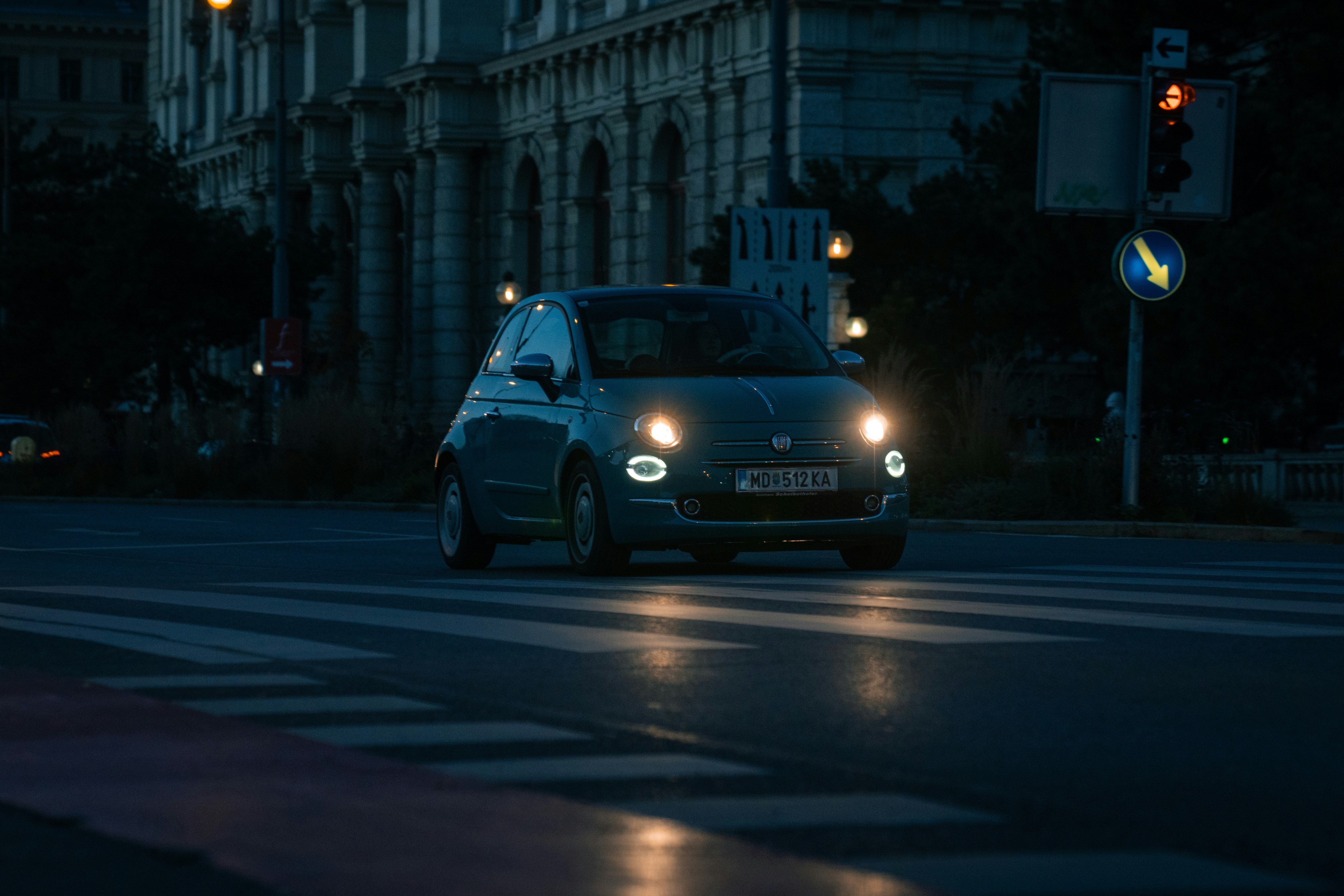 Audi Q4 e-tron driving through a modern city street at dusk