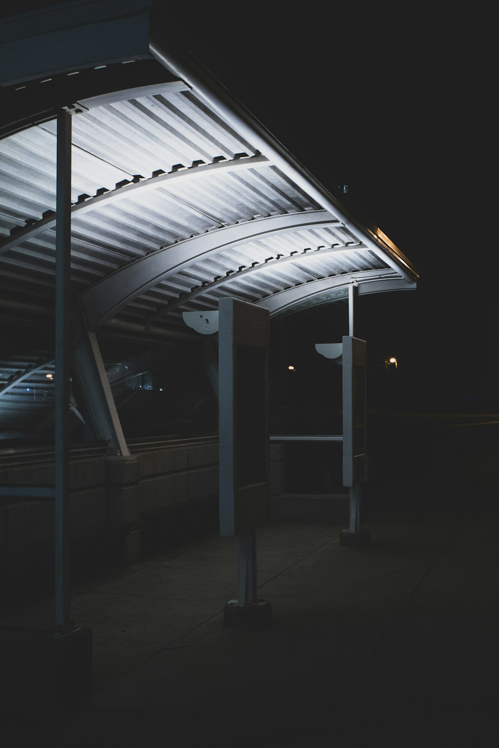 a bus stop at night with the lights on