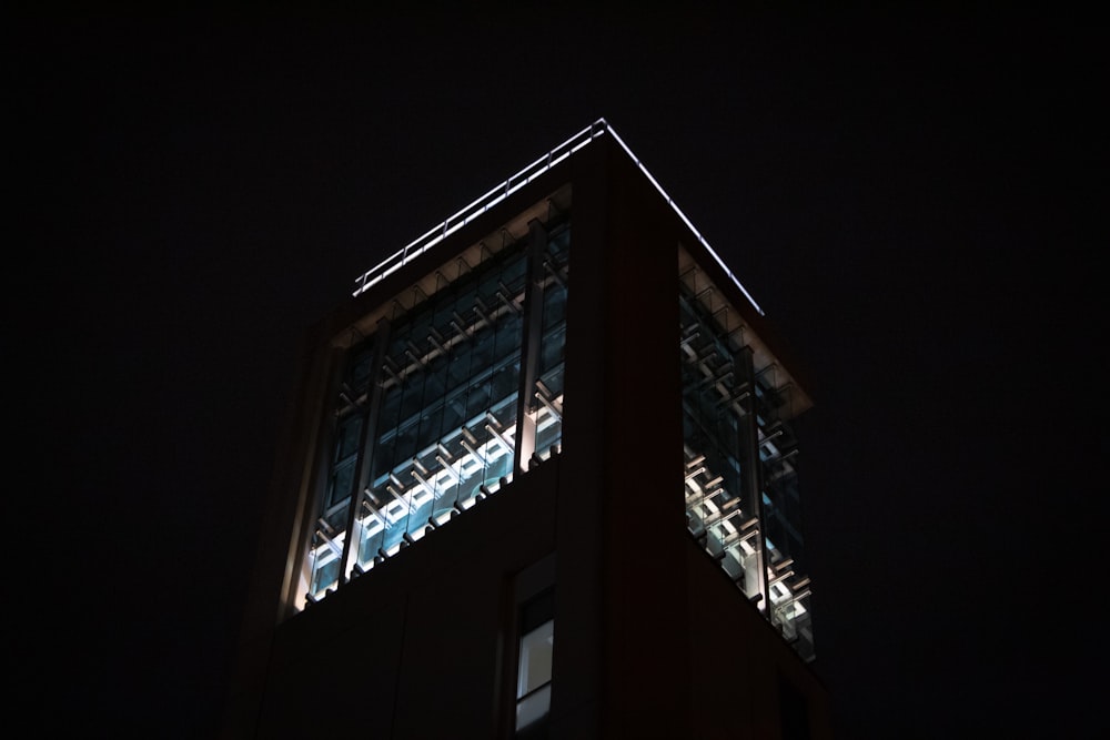 the top of a tall building lit up at night