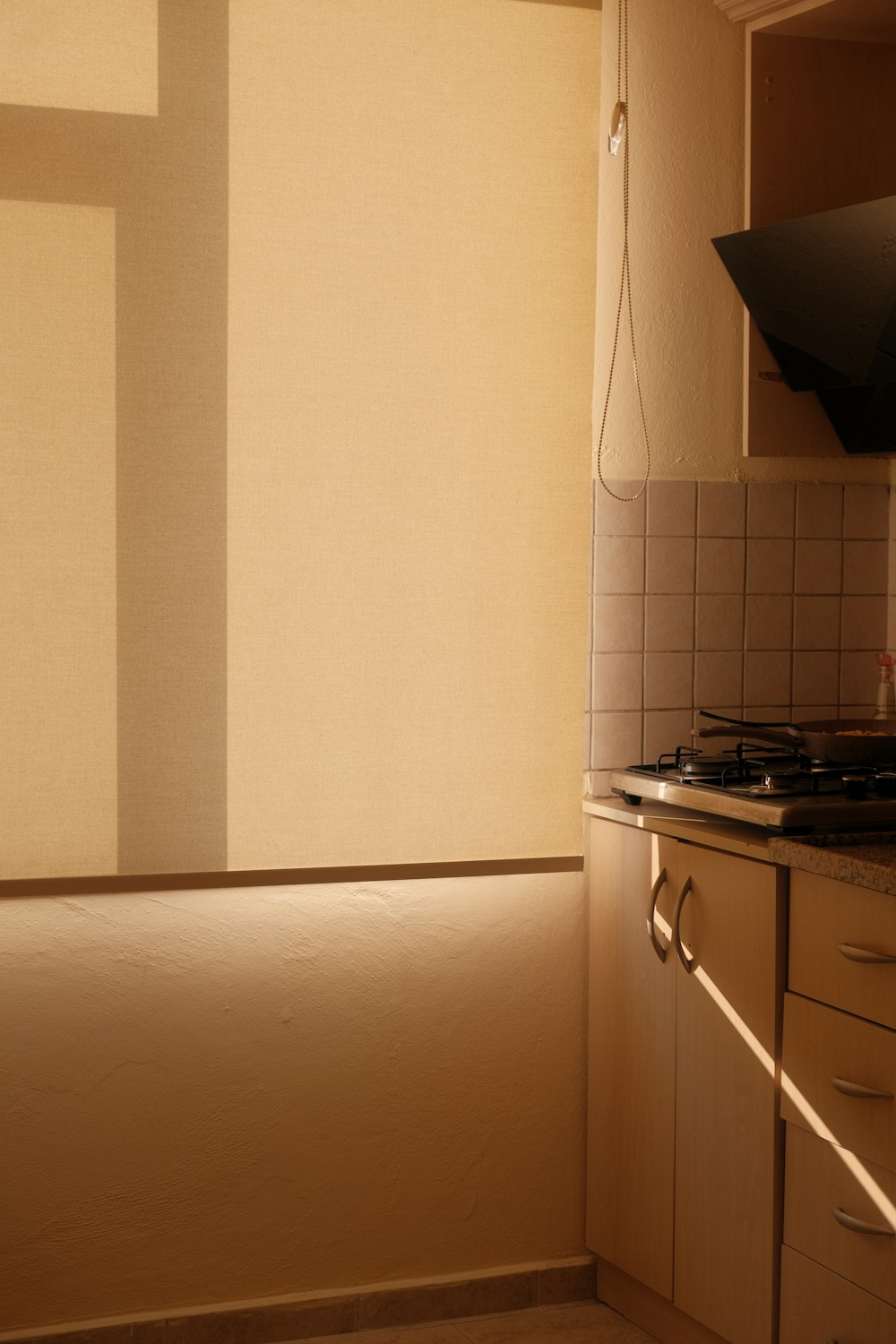 a kitchen with a stove top oven next to a window