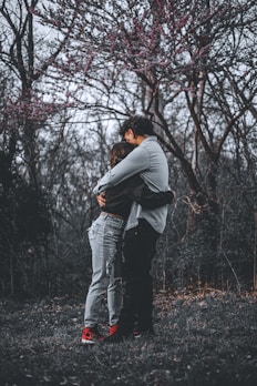 Illustration of a heartfelt romance novel cover with two characters embracing under a blooming cherry tree.