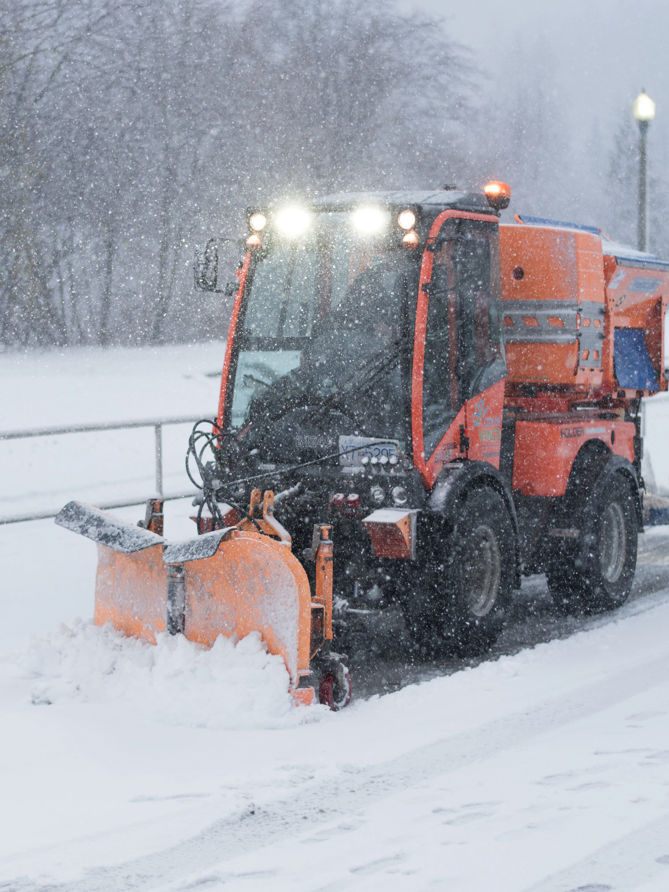 Snow plow clearing a snow-covered road