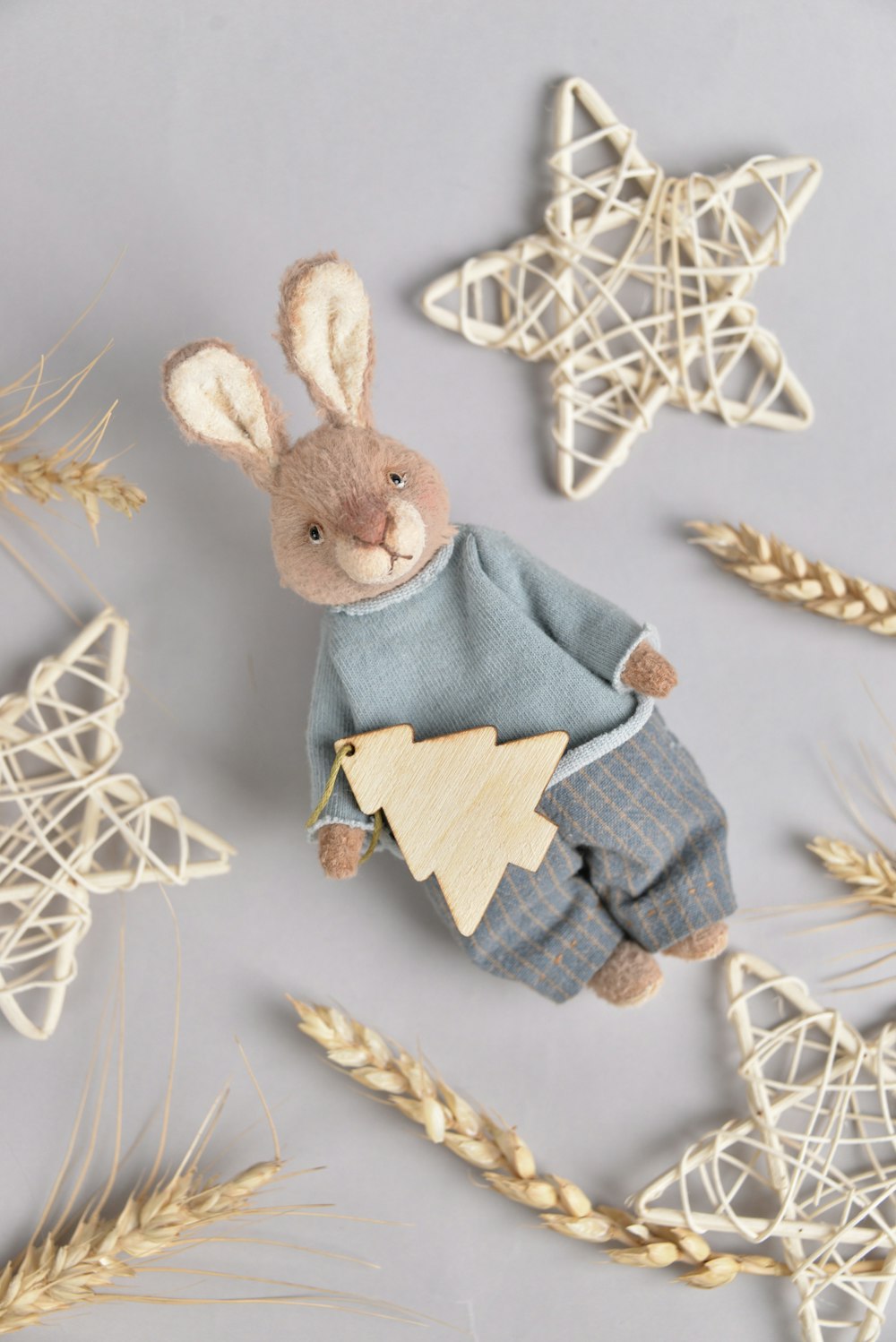 a stuffed rabbit in pajamas and a star ornament