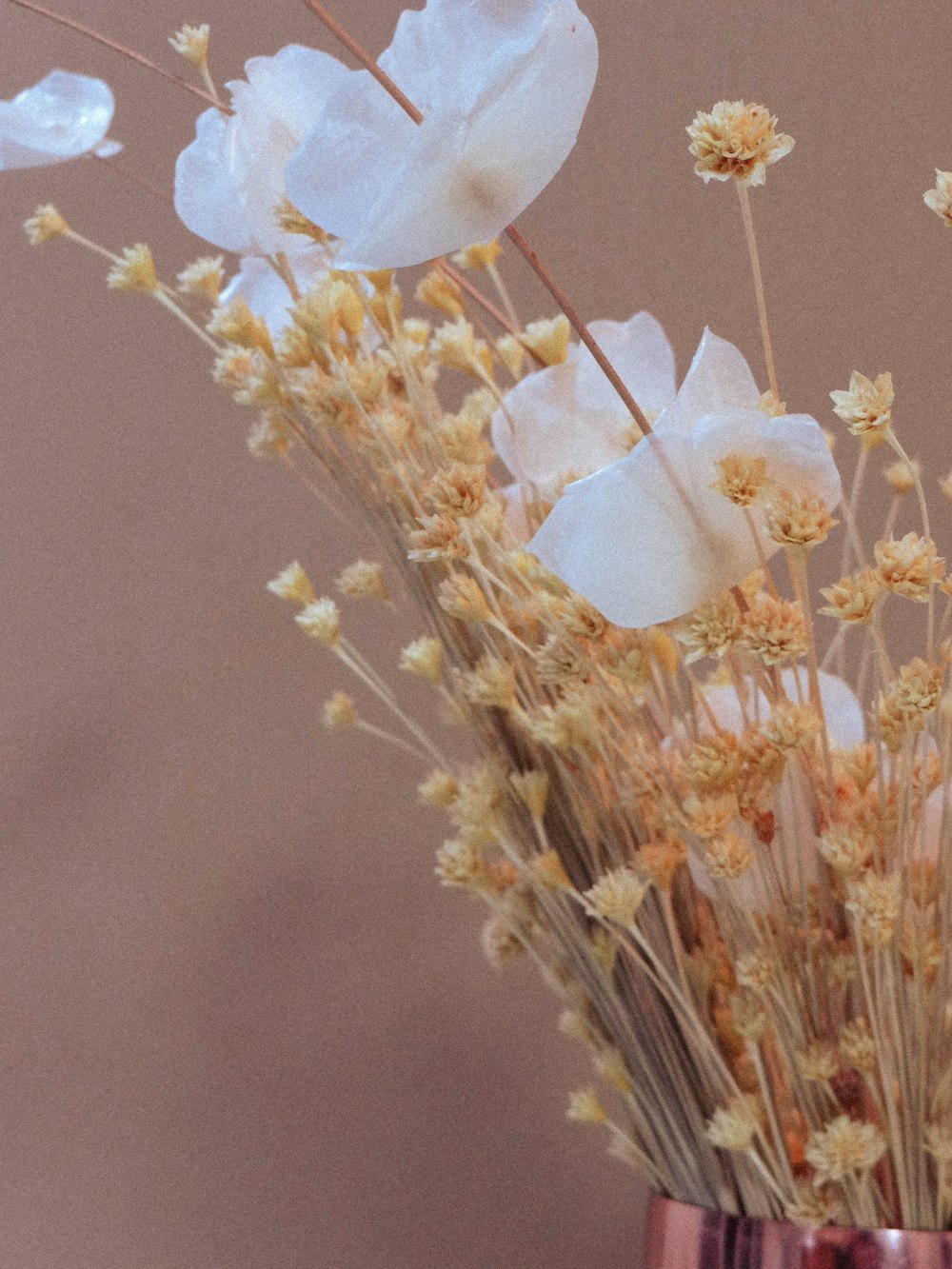 a vase filled with white flowers on top of a table