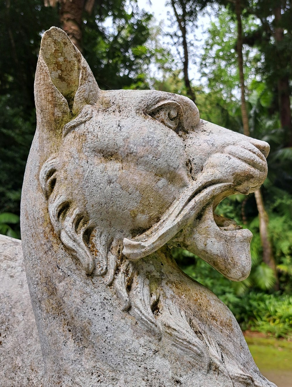 a statue of a cat with its mouth open