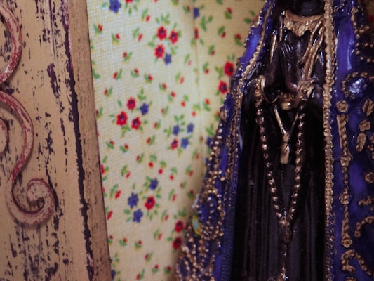 A detailed poster print with an alluring, artistic figure surrounded by floral motifs.