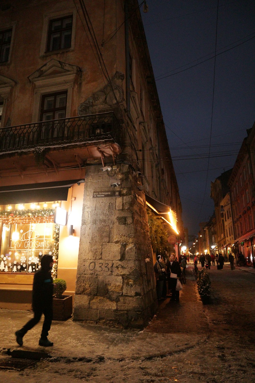 a person walking down a street at night