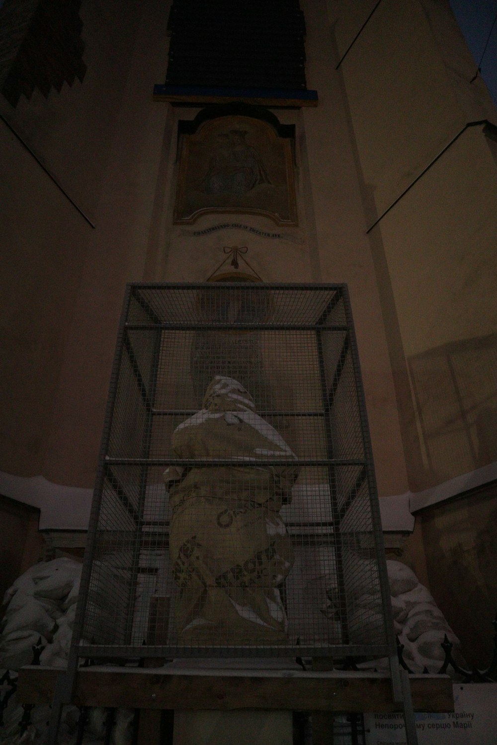 a metal cage with a picture of a man inside of it