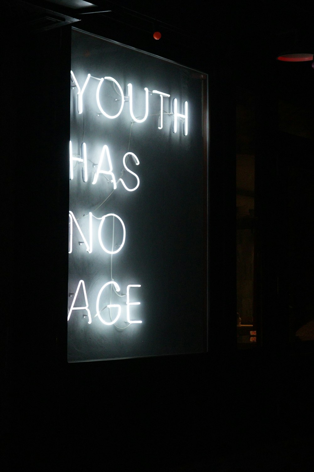 a neon sign that says youth has no age