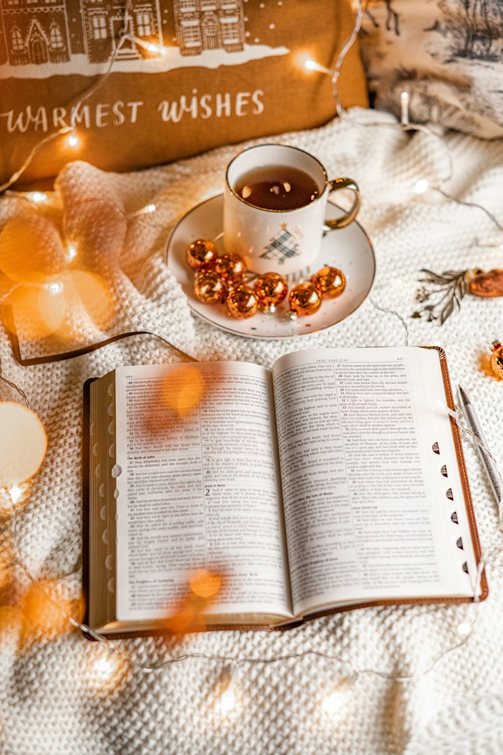 a cup of tea and a book on a bed