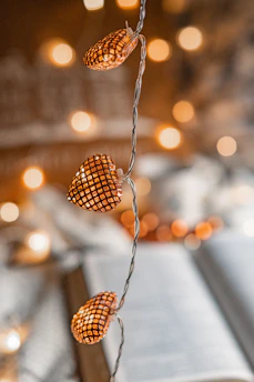 Close-up of cozy lights casting a gentle glow over a reading nook.