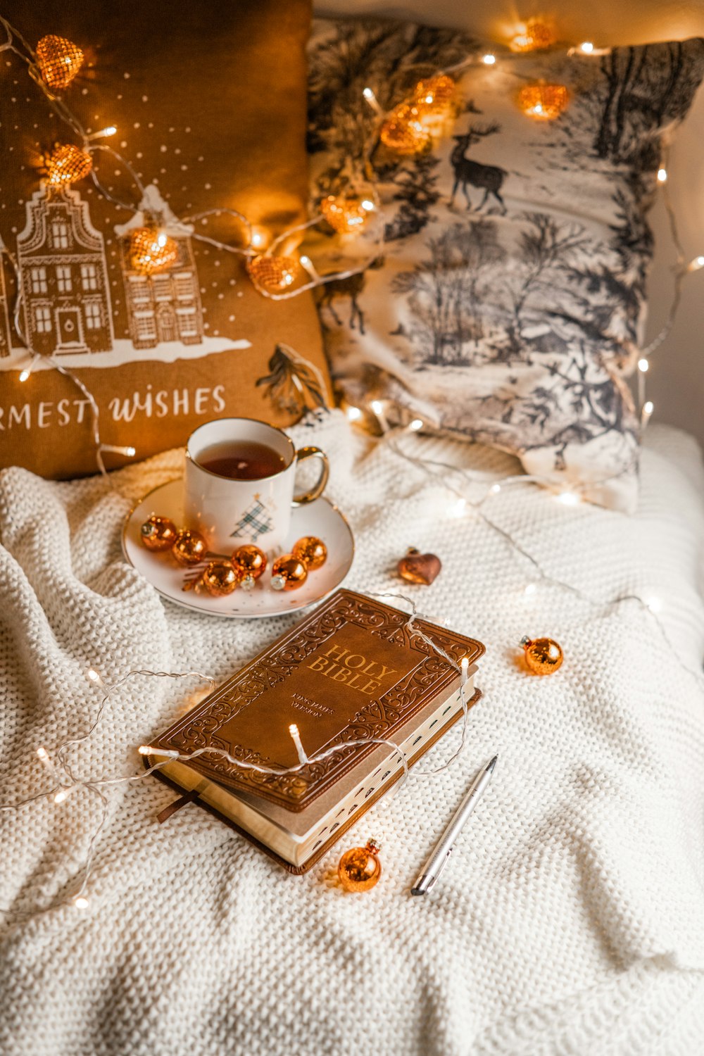 a cup of coffee and a book on a bed