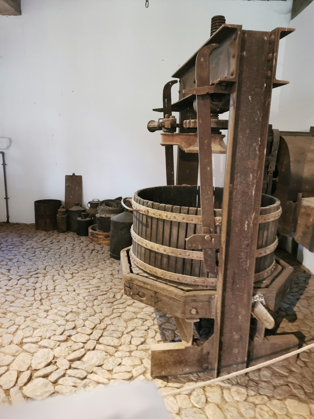 a large wooden bucket sitting on top of a stone floor