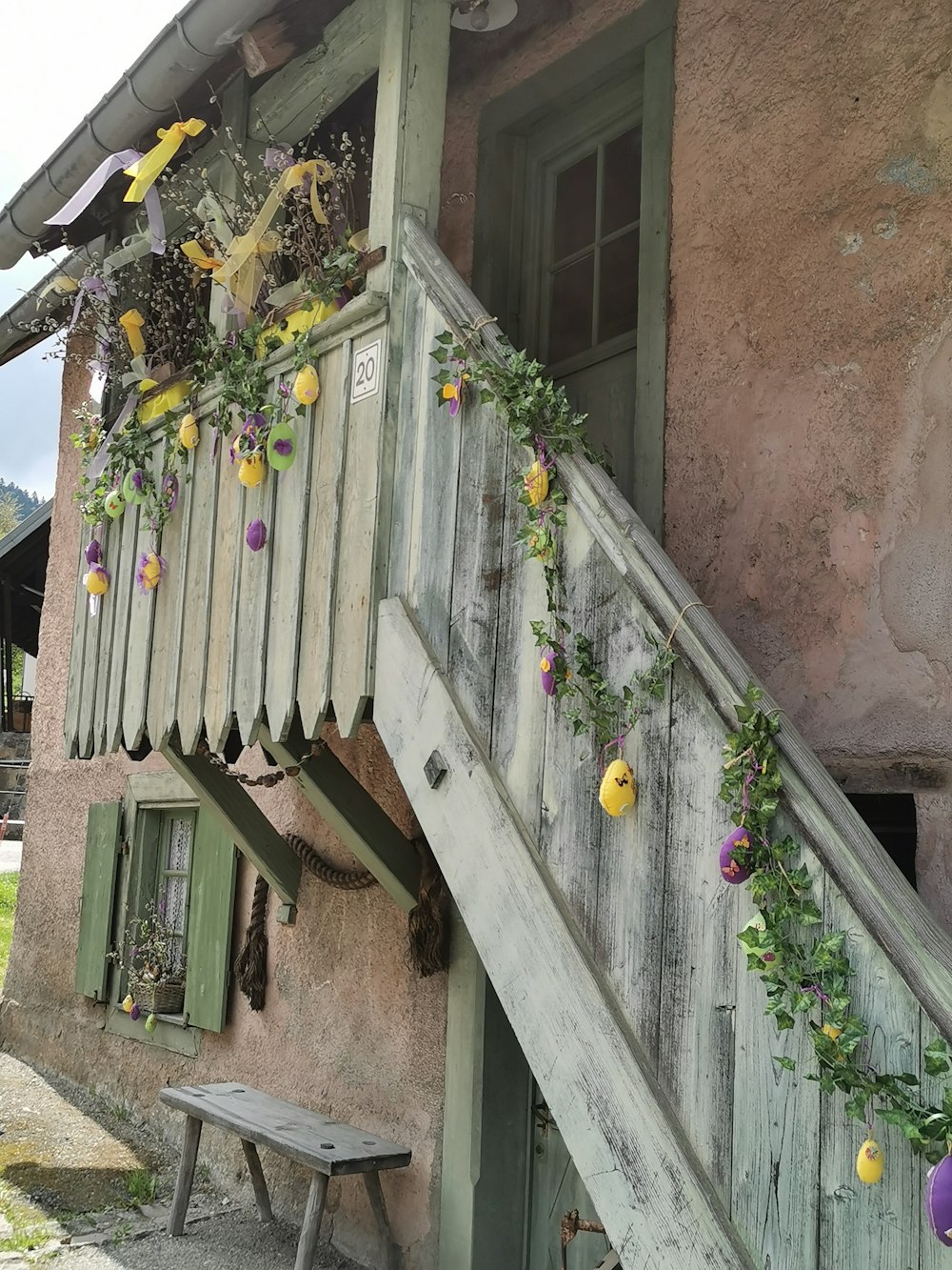 a house with flowers growing on the side of it