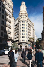 A vibrant cityscape of Buenos Aires with people walking toward a brighter future.