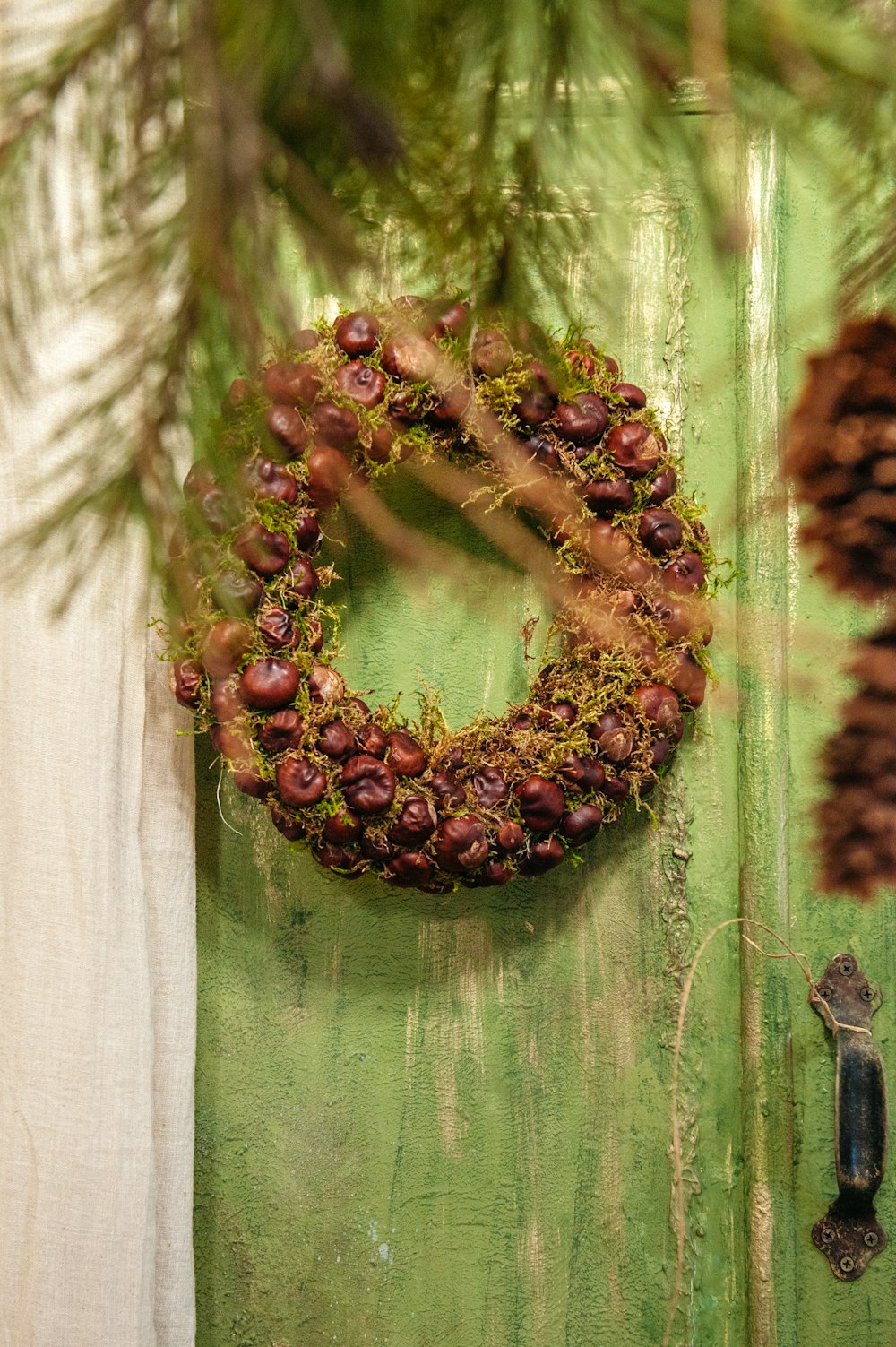 a green door with a wreath hanging on it