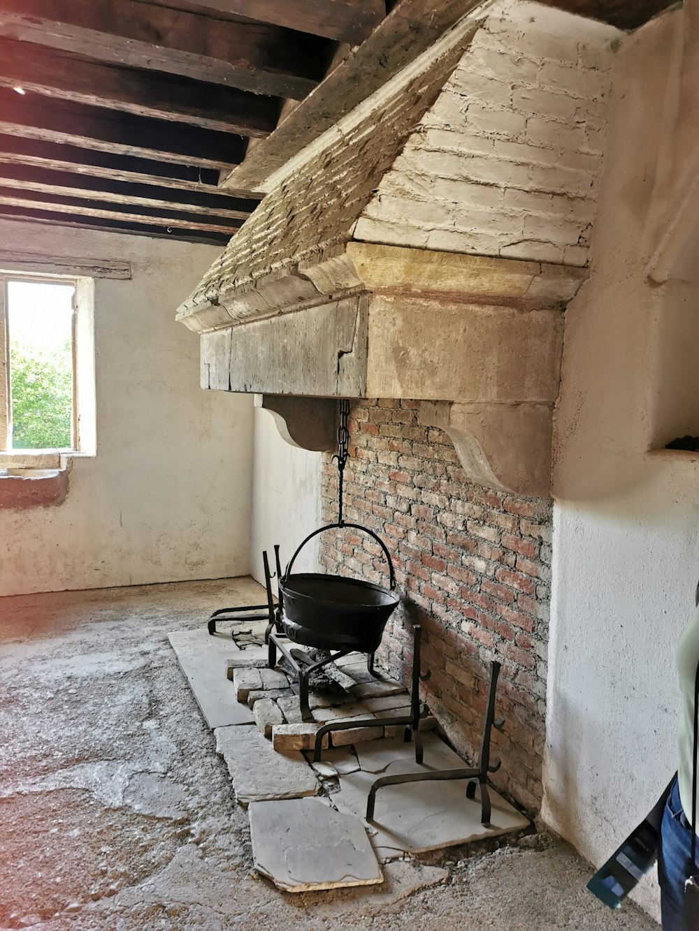 a room with a brick wall and a grill