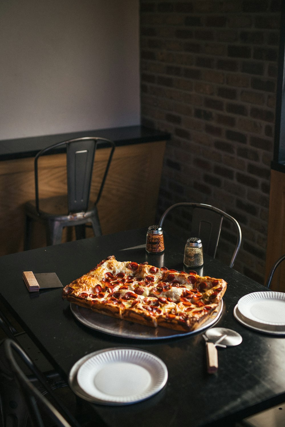 a pizza sitting on top of a pan on top of a table