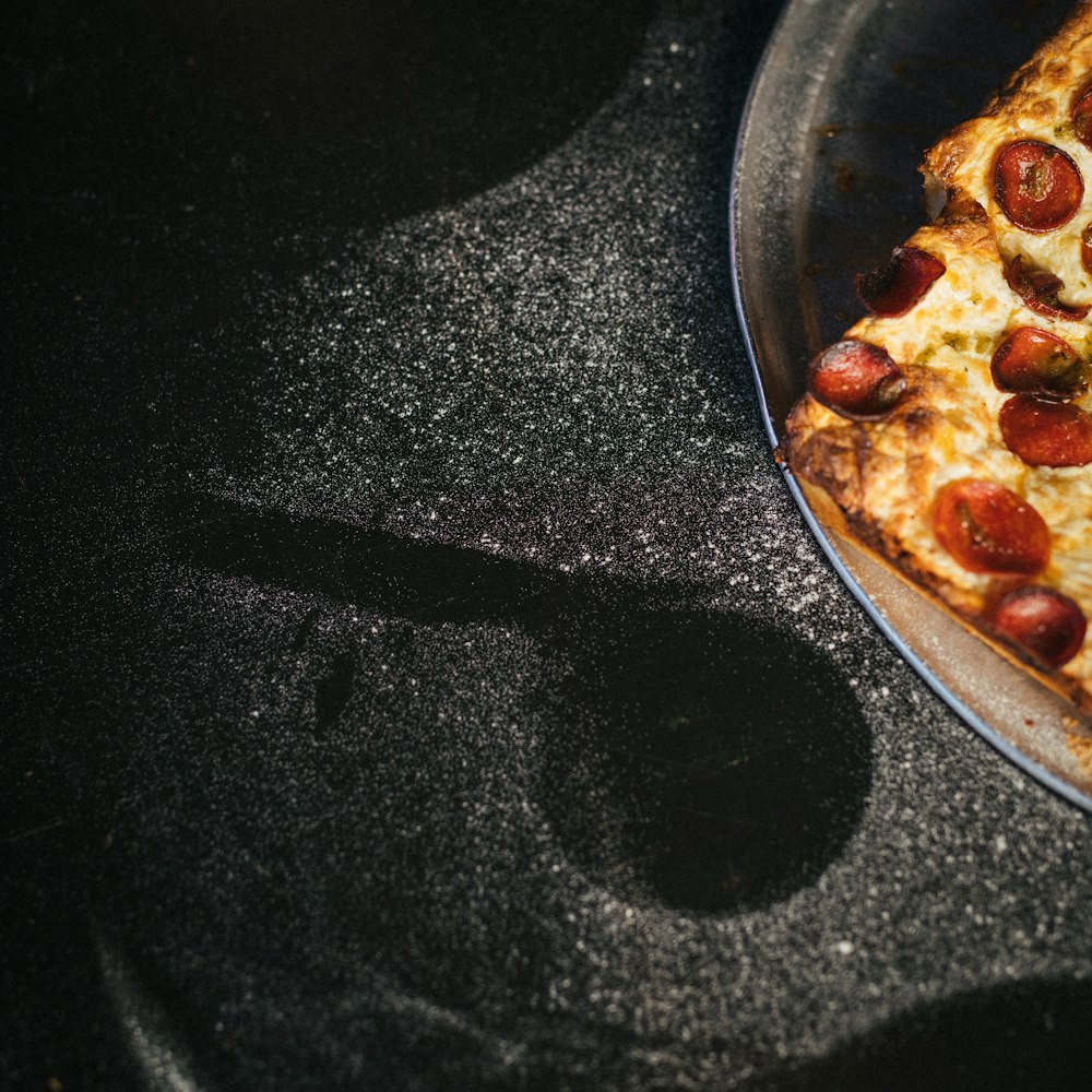 a pizza sitting on top of a pan on top of a stove