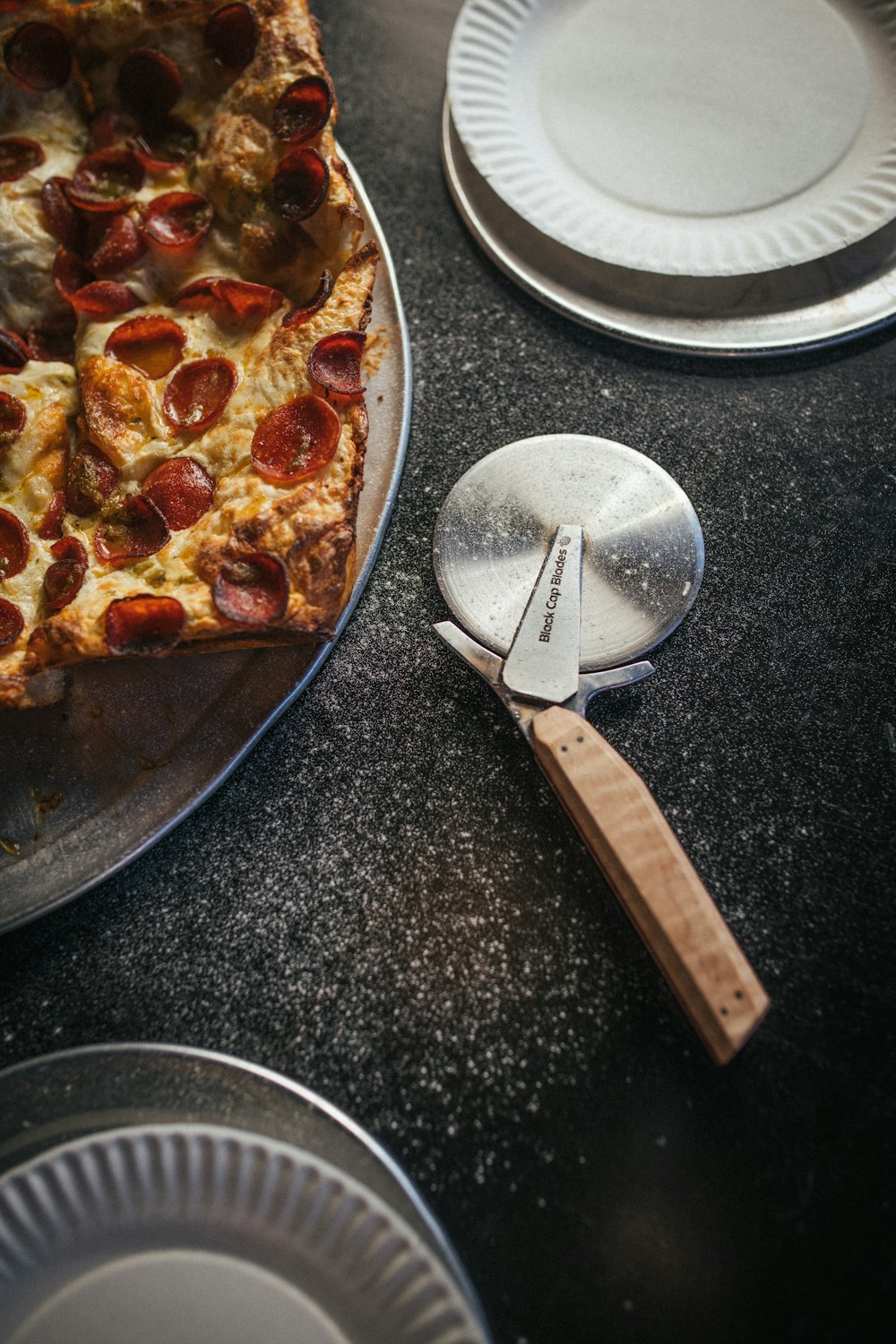 a pizza sitting on top of a pan on top of a table