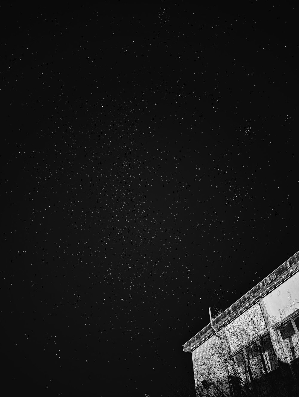 a black and white photo of the night sky