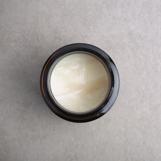 a jar of cream sitting on top of a table