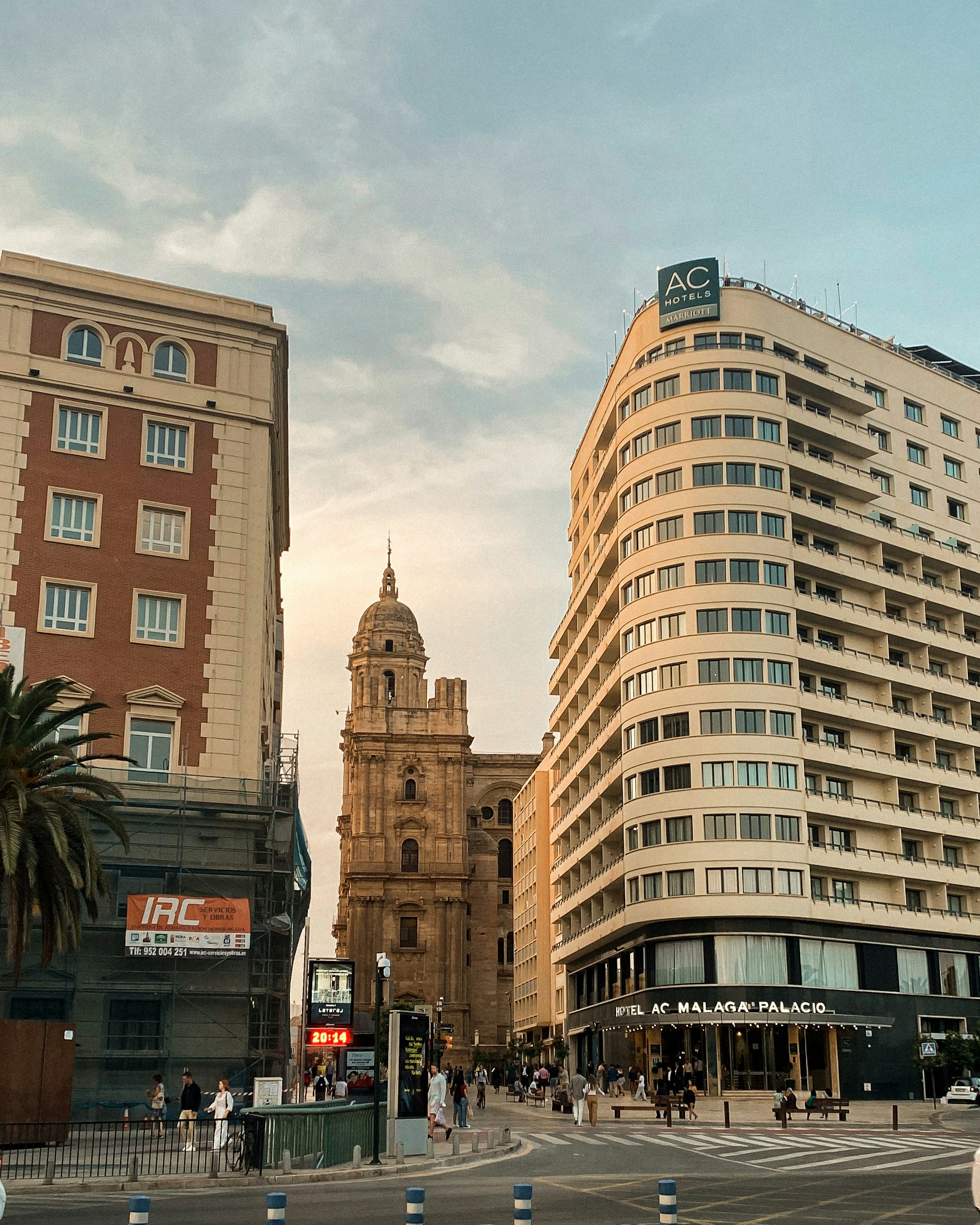 a city street with tall buildings and a clock tower