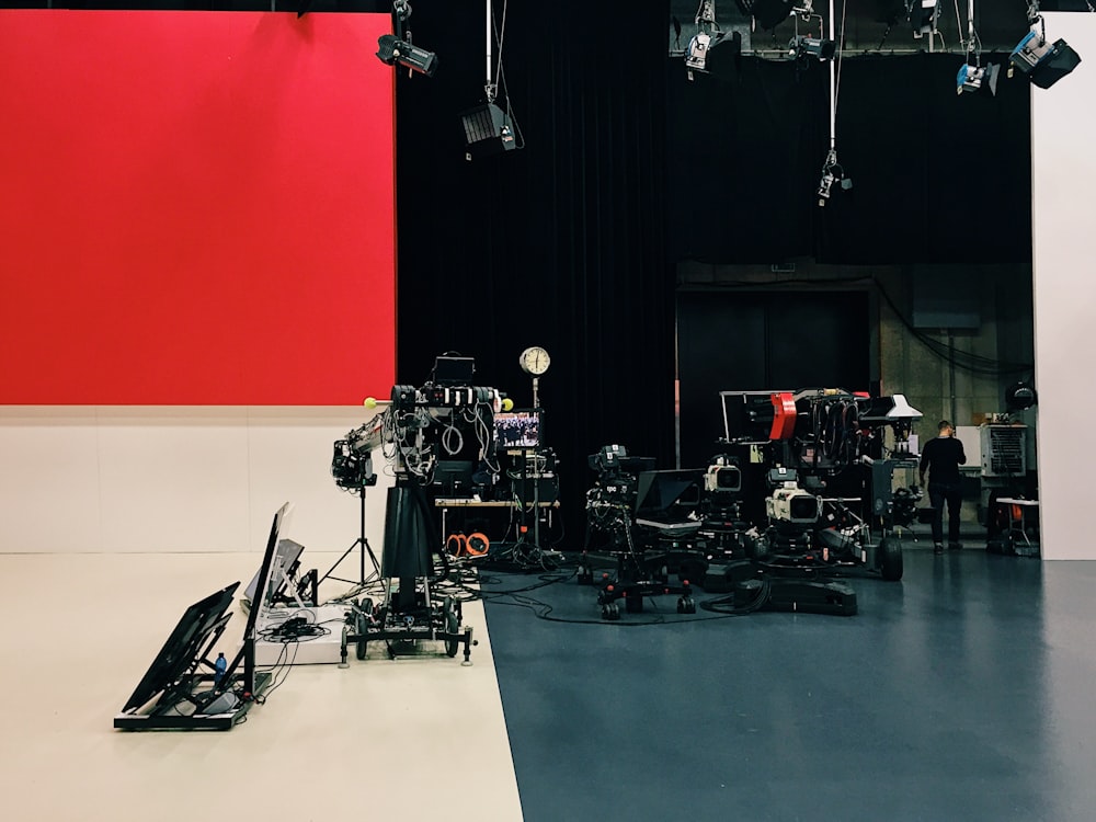 a camera set up in front of a red and white wall